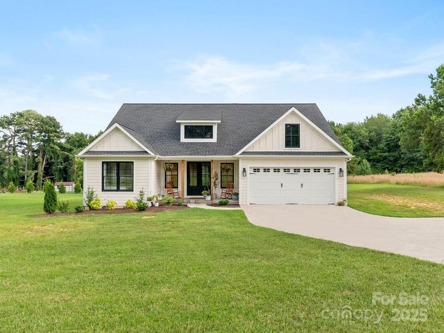 Welcome to this stunning custom-built Craftsman style residence, just two years old, is nestled on a level, half acre lot. As you step inside, you'll be greeted by glistening oak hardwood floors that flow throughout the home, complemented by stylish tile in the bathrooms and laundry room. The living room boasts soaring ceilings, a captivating stone fireplace, and a charming farmhouse feel. Featuring an oversized garage and an expansive screened-in porch, this property is perfect for entertaining or simply enjoying the peaceful surroundings. The primary bedroom is a true retreat with vaulted ceilings, a spacious tile shower, a luxurious garden tub, and his and her sinks, all leading to a roomy walk-in closet. The gourmet kitchen is a chef's delight, outfitted with stunning stainless-steel appliances, quartz countertops, and a large walk-in pantry for all your storage needs.  No HOA, no restrictions and highly sought after District 1 schools!