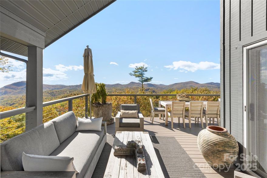 Escape to a quiet mountaintop retreat where privacy, serenity, and long-range views define everyday living. Set on a gently rolling ±2.5-acre site in the gated Big Sheepcliff community, this Mountain Modern home enjoys seclusion while remaining minutes from Cashiers Village. A waterfall along the drive signals your arrival and sets the tone for the peaceful setting.

Inside, the home offers inviting spaces designed for comfort, quiet moments, and effortless hosting. Large windows frame ever-changing vistas, and decks with outdoor living spaces capture panoramic views of Whiteside and Yellow Mountains, Lake Glenville, and beyond. An all-season sunroom enhances year-round enjoyment, and the finished lower level provides flexible space for guests or extended living.

This property balances convenience with privacy—close to dining, culture, and recreation, yet tucked away in one of the area’s most discreet enclaves. An elegant opportunity to experience mountain living.