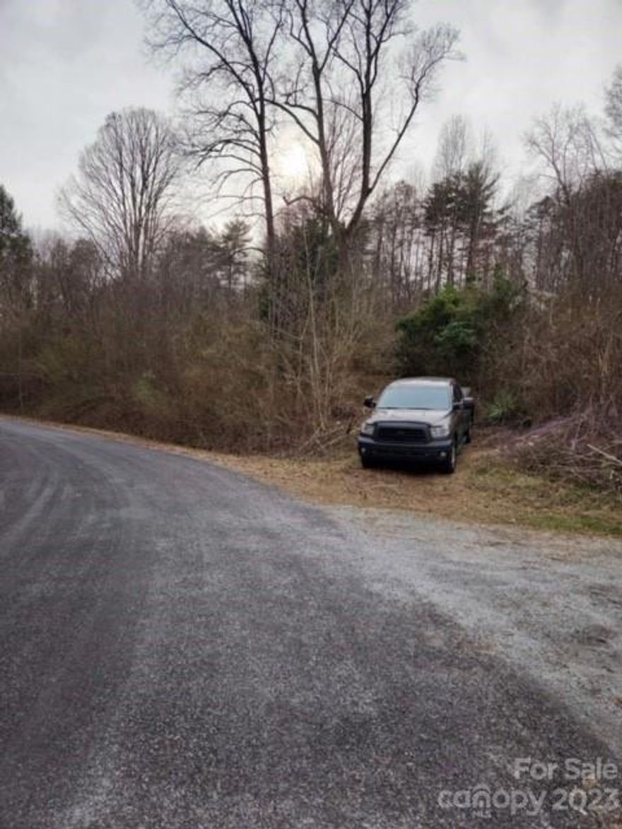 2.57 ac  to build on Paved Public road   county water available with paid tap old septic  on property 
there is an older house on property  and chicken coop  please DO NOT ATTEMPT TO ENTER OLD HOUSE OR WALK ON PORCHES