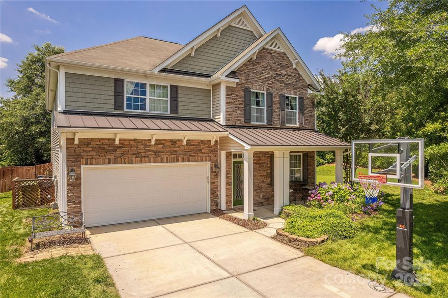 Get the best of both Carolina’s with this former model home in Fort Mill’s desirable Fair Oaks. Situated on a premium corner lot, this 5 bedroom home w/ guest suite on the main has been beautifully updated & is move-in ready. Hard surface floors unite the open concept floor plan. Formal dining room flows seamlessly to updated Chef’s kitchen w/ refinished cabinets, granite counter tops, tile backsplash & stainless appliances. Large great room w/ fireplace is ideal for entertainment or relaxation. Enormous primary suite w/ sitting room features large walk-in closet & en suite bathroom including glass enclosed shower, garden tub & double vanity.  2 additional generously sized bedrooms plus large 5th bedroom/bonus room. Relax on the expanded patio complete with pergola on the privacy fenced backyard surrounded by mature landscaping. Conveniently located on the state line, minutes from Rivergate Shopping yet with award winning Fort Mill schools and SC taxes, this is one you need to see!