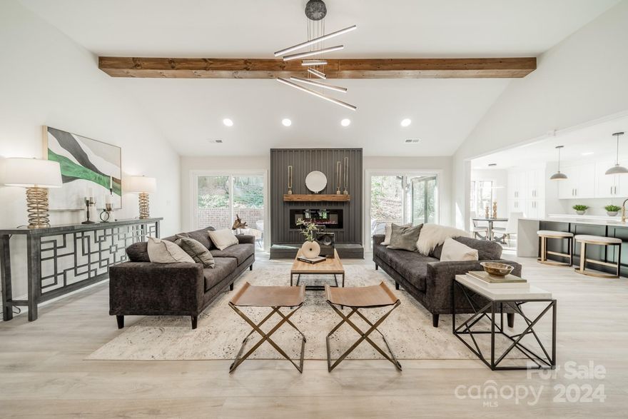 Live the LAKE LIFE at gated River Hills in this 4-bed home transformation! Step through the grand double front doors to see everything is updated -a gleaming kitchen & waterfall island styled in quartz & all new appliances, a coffee bar niche, an open concept airy great room with wood-beamed high ceilings, fireplace, new sliding doors to the patio, dimmable recessed lighting + modern light fixtures and LVP & tile floors throughout. Wait until you see the primary bedroom: walk-in closet with custom built-ins, accent wall & a dreamy bathroom with enormous walk-in shower, soaking tub, glossy cabinetry & LED mirrors with lighting.  Guest bedrooms/office include new ceiling fans.  Exterior is complete with a new roof, new gutters, board & batten siding, fresh paint, motion lights & a Ring doorbell. Enjoy a large 2-car garage with extra storage in back. Downstairs level laundry area includes sink & cabinets and the crawl space has a new vapor barrier & insulation.