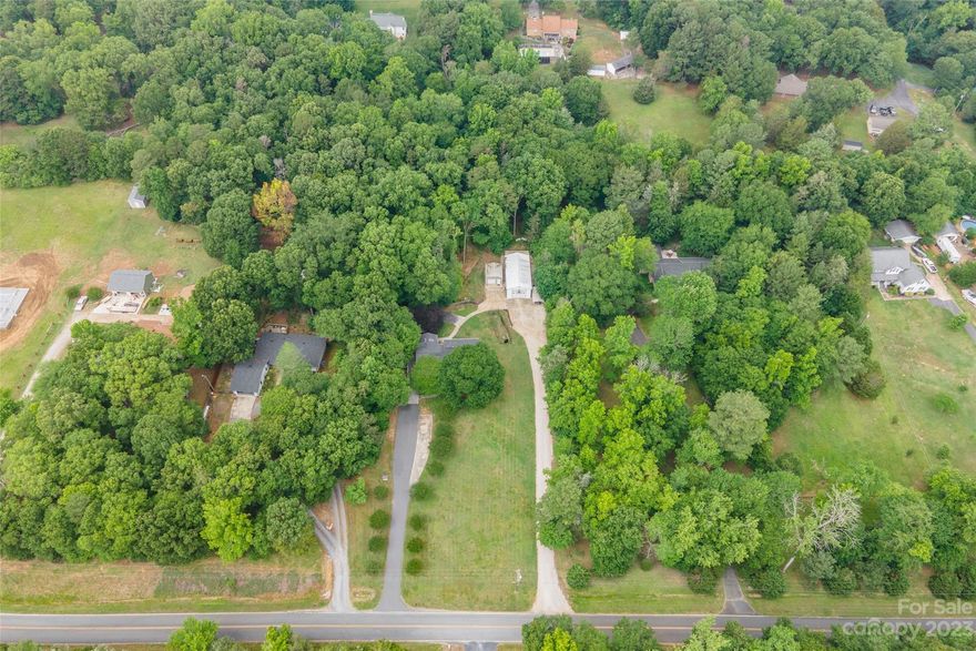 This house has it all! No HOA! Split level home with bright sunroom on main and a beautifully wooded and private lot. Spacious great room with brick fireplace (sealed, never used, sold as-is), beams, and classic bead board. Four bedrooms, 2.5 bathrooms, and an amazing great room in the lower level that makes a dynamic bonus area. Tons of attention to detail inside and out! Plenty of space to store all your toys with a rare RV/Boat Garage, workshop, plus 2 detached garages. Stone patio in backyard is a lovely place to grill and enjoy the whimsical back yard.