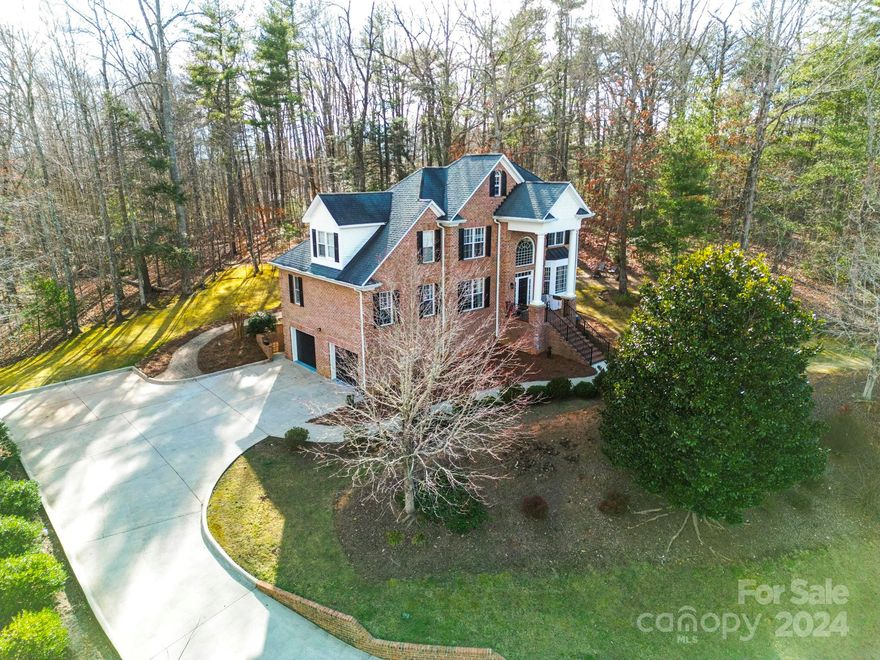 Beautiful 4 bed 3 1/2 bath home built on 2 lots, providing a park like feeling.  The front porch overlooks the koi pond with waterfall.  The huge basement, double garage provides plenty of parking and storage.  An elegant staircase greats you as you enter the home with a private office located to the left.  The kitchen opens to both a breakfast area as well as a separate dining room with tray ceiling.  Granite Counter tops, gas stove and natural lighting make this kitchen beautiful and inviting.  The primary bedroom, on the main level, opens into a large private bath with both a tub and separate steam shower!  The laundry is on the main level adjacent to a guest 1/2 bath.  The 2nd level has 3 bedrooms with a full bath and walkway overlooking the family room and fireplace.  The basement has a large entertaining/recreation room with separate full bath.  See the seller's list of updates and improvements!  Sellers offering a 1 year home warranty!