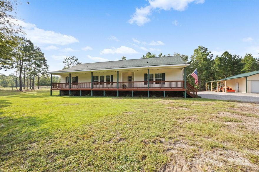 Discover your private homestead on nearly 10 acres of agriculturally zoned land, designed for both comfort and functionality. The property includes a 6-stall horse barn with two attached paddocks, four horse stalls, one grooming stall, and a dedicated tack area—all enhanced by a built-in fly spray system with automatic timer. Two deep wells (approx. 132 ft) supply fresh water separately to the home and the barn. Arena lights, powered by solar panels, illuminate the pastures for evening rides, while additional sheds and a detached 2 bay garage with workshop and tractor shed allow for ample storage and work-space.  Fenced garden beds, and wooded privacy throughout the grounds. Separate electric meter for the barn in case used for boarding horses and could be a separate business.  Back fenced pasture is 6 acres with 3 acres planted in Bermuda grass that is drought resistant. All acres were fertilized in the spring. Relax in the fiberglass saltwater pool (4–5 ft deep), or take in the peaceful surroundings from the covered front porch or screened back deck.Inside, the home welcomes you with elegant architectural details including arched entryways, crown molding, and thoughtful finishes throughout. A new roof was added in 2023, giving peace of mind for years to come. Whether you envision a working farm, equestrian lifestyle, or simply a serene retreat, this property delivers the perfect blend of rural charm and modern convenience. Modular home built by Carolina Country Homes.