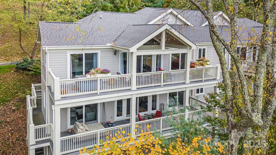 Experience refined mountain living at 4,500 feet elevation in this turnkey 5-bedroom, 3.5-bathroom fully furnished Mountainside Townhome inside the gates of Wolf Laurel Resort—a private, year-round, gated mountain community less than 35 minutes from Asheville, Johnson City, Burnsville, and Weaverville. Resort-style amenities are within walking distance, including the Wolf Laurel Country Club, Fitness Center, and Golf Course.

Offering 3,199 sq ft of beautifully finished living space with four fireplaces, an attached two-car garage, and two expansive 488 sq ft decks—one featuring a hot tub and the other a swing bed—this residence combines high-elevation comfort with luxury design. An additional 845 sq ft unfinished basement with 12’8” ceilings offers exceptional potential for expanded living space or an impressive wine cellar.

The entrance level features a welcoming living room, kitchen, and dining area, along with the primary suite, which includes an en-suite bath, two closets, and direct access to the main deck overlooking panoramic long-range mountain views.

Upstairs, the second level offers another living area, a second bedroom with en-suite bath, and a third bedroom with a full bath for family or guests. Two large bonus rooms add valuable flexibility—one currently used as a media and office space, and another as a private workout and music room. Both could serve as additional bedrooms, hobby spaces, or multipurpose flex areas, offering versatile options for future owners. The second level also provides access to the upper deck from three rooms, where the swing bed invites you to unwind and enjoy cool mountain breezes.

The gourmet kitchen features premium appliances, including a SubZero refrigerator/freezer, WOLF gas range and oven, and dual BOSCH dishwashers. A steam shower, updated lighting, and fine finishes throughout add a touch of understated luxury to this move-in-ready home.

This end-unit townhome enjoys exceptional privacy, with no neighbor on one side, and the property extends to the cul-de-sac. Step onto your decks to enjoy all-season mountain views—spectacular in winter, lush in summer, and vibrant during fall foliage. The attached two-car garage provides secure parking and extra storage—another rare and valuable feature within Wolf Laurel’s mountain terrain. Connected to community sewer service, a rare amenity in Wolf Laurel where most homes rely on septic systems, this property offers low-maintenance convenience and long-term value.

Outdoor enthusiasts will love the home’s direct access to the Wolf Laurel Nature Trail, which connects to the Appalachian Trail just a short walk away, plus miles of biking and hiking trails throughout the resort. The upcoming Hatley Pointe Adventure Bike Park, opening in 2026, will further enhance the area’s appeal to cyclists and adventurers.

The Wolf Laurel Country Club is a private, member-owned club featuring a world-class chef, full bar, and extensive wine list, offering fine dining with breathtaking mountain views. The resort provides year-round recreation including Hatley Pointe Ski Resort, golf, tennis, heated seasonal pool, pickleball, stocked trout pond, hiking, and equestrian facilities, all surrounded by thousands of acres of protected wilderness and Pisgah National Forest. The home’s proximity to Hatley Pointe’s Smoke & Timber Restaurant—just a short drive inside the gated Wolf Laurel Resort community—provides convenient, year-round dining and a welcoming gathering place for residents and visitors alike.

Whether you’re seeking a primary residence, vacation retreat, or income-producing investment, this Mountainside Townhome at 4,500 feet elevation delivers an unmatched combination of luxury, location, and high-elevation adventure within one of Western North Carolina’s most desirable gated communities.