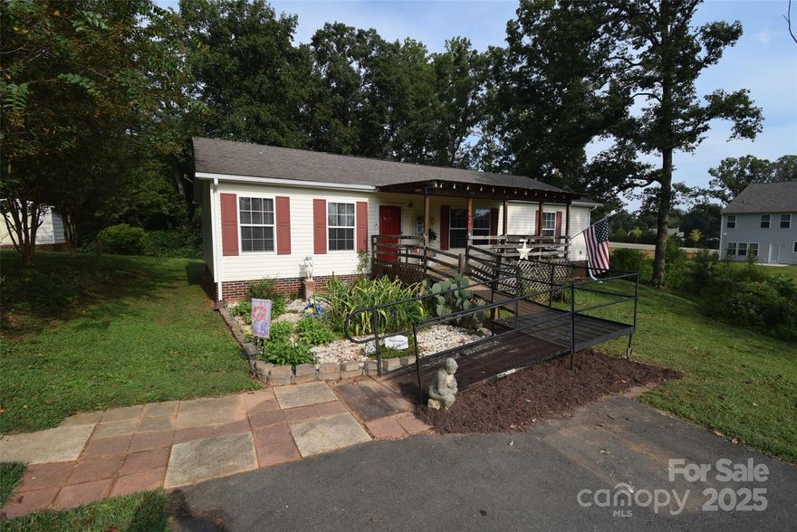 ****2/25/26 The town of Dallas is working on utility lines in the area of the home. This is impacting traffic for showings. The traffic is somewhat heavier at this time due to that.****
Come check out this 3-bed, 2 full bath home in a very convenient location just outside the city limits of Dallas, NC.  Inside, you will find spacious rooms throughout, with a split bedroom floor plan; no space is wasted on a long hallway.  An open living area makes for easy entertaining, or keeping up with the score on the ballgame, or watching over loved ones while cooking. The primary suite features a walk-in closet, a private bath with a stand-up shower, and a linen closet. Outside, you will find a large covered front porch and a fenced area in the back that offers convenience for pets. There is plenty of land to put a storage building on or possibly a garage on the large .81 +/- acre lot. If you are looking for a large lot, no City Taxes, no HOA, 3 bedrooms, and 2 full bathrooms. This is one you need to check out!!!