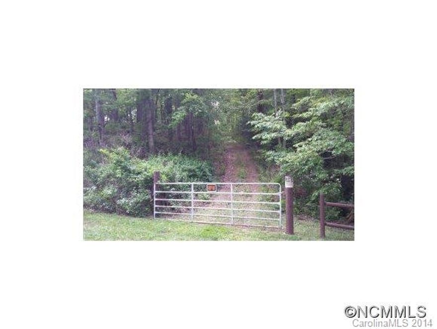 Private, wooded acreage borders NC Wildlife Gamelands. Gentle rise to the ridge with winter views over the valley. Native azaleas, rhododendron, wildlife abounds. Most pins marked. Deed restrictions say log house only. Triangle of land at front has building setback (see survey). Access by 4-wheel drive. Key to gate in lockbox at gate corner. Wonderful spot to get away from the hustle & bustle-relax & enjoy country living!