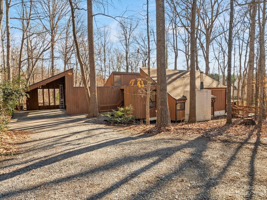 Enjoy the feeling of being away from it all, and be just 5 minutes from daily conveniences. This one-owner home is situated on a 2.28-acre wooded lot minutes from Reedy Creek Park. This expansive contemporary home offers character and charm with tons of natural light. The cozy, yet spacious living room has a wood stove, built-in firewood storage, and a breakfast nook overlooking the front yard. There is a deck off the dining area with access to the side yard. The kitchen has ample storage and a picture window overlooking the screened-in porch and backyard. The main level primary bedroom suite has built-in bookshelves and storage, large windows and a sliding door offering access to the screened-in porch. Both secondary bedrooms have built-in desks and storage. The partially finished basement offers a recreation area and storage, a bathroom, hidden storage, and a large workshop. There is a garden area and a fenced area that is ideal for your furry friends. Lots of storage throughout