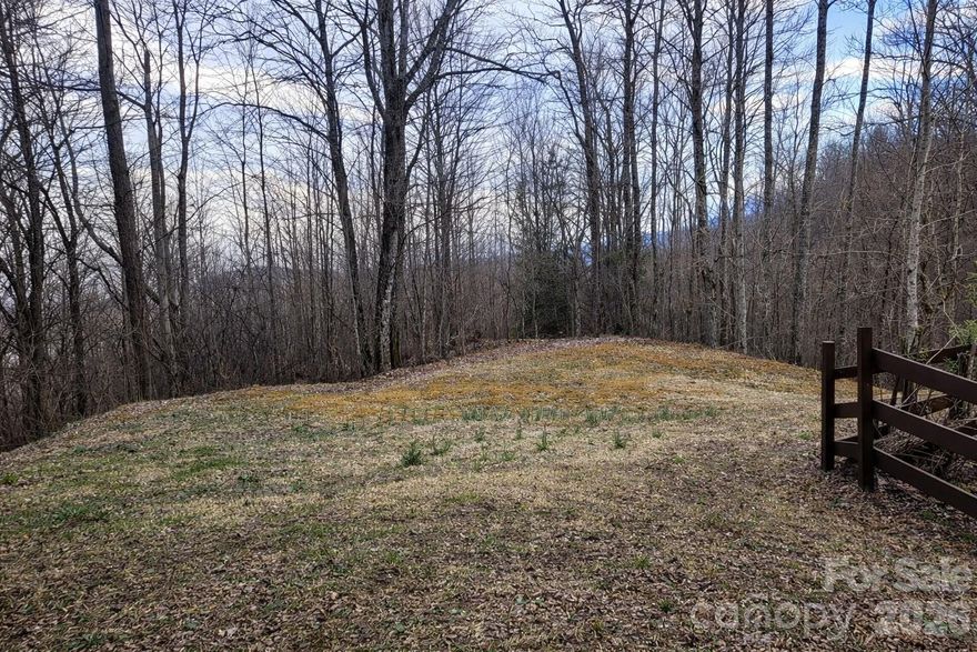 Discover the potential of 00 Upward Way in The Willows community of Jonathan Creek, a beautiful mountain homesite in Waynesville offering the perfect setting for your future retreat. As the first lot beside the gate upon entering the community, this parcel enjoys an easy-to-find location and a welcoming approach. The land opens with a rolling, grassy area that would make an excellent homesite, then slopes behind it creating an ideal layout for a mountain home with multiple levels and a walkout basement.

This property is tailor-made for the buyer seeking to build a true Western North Carolina-style home, whether that means a cozy log cabin, an arts-and-crafts mountain cottage, or a striking timber frame residence tucked into the natural landscape. With some tree trimming and thinning, the lot may offer long-range mountain views year-round, while current winter views already showcase the beauty and promise of the setting. The topography, natural character, and view potential combine to create a homesite that feels both inspiring and practical.

Perfect for a primary residence, vacation home, or second-home escape, this lot invites you to build a place where mornings begin with mountain air and evenings end with ridge-line views. Opportunities like this, offering a build-friendly homesite, classic mountain character, and the chance to create something truly special, are exactly what buyers envision when searching for land in the North Carolina mountains.