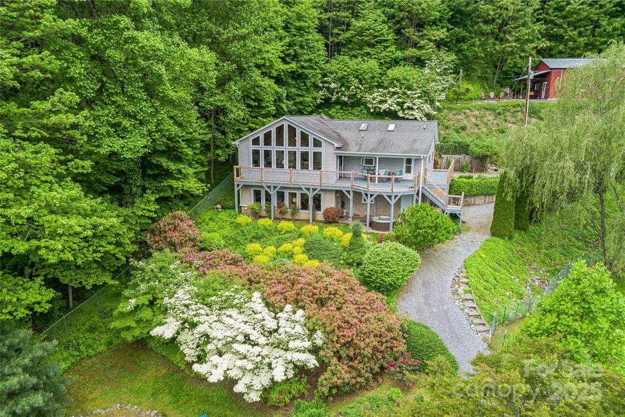 MOTIVATED SELLERS! NO OFFER IGNORED. Commanding long-range mountain views define this exceptional haven. Designed for comfort & inspired by nature, this home is bathed in natural light through expansive windows framing panoramic vistas. The main level offers effortless one-level living with two primary suites, vaulted great room with a wall of glass, statement fireplace, & custom built-ins. Step outside to a covered deck ideal for quiet contemplation, surrounded by vibrant gardens & landscaping. The lower level features a family room, guest quarters, & bonus room for a studio, gym, or media space. The building above accommodates RVs & more with ease, while the workshop—complete with pub-style charm—adds creative potential. The grounds are brimming with options: raised garden beds, berry bushes, pear trees, greenhouse, & natural rainwater irrigation. Enjoy mesmerizing sunrises or unwind beneath the stars in your private hot tub. A peaceful retreat, sustainable lifestyle, homesteading haven, or work-from-home sanctuary—this property delivers it all. Short Term Rentals allowed!