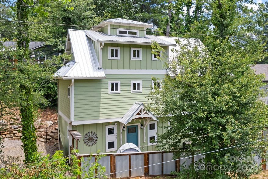 Modern design meets mountain charm in this stylish West Asheville home, perfectly positioned on a sunny corner lot between the sought-after Malvern Hills and Bear Creek neighborhoods. Built in 2020, this light-filled home boasts tall ceilings and striking architectural details that create an open, airy feel throughout. With two spacious bedrooms, two full bathrooms, and a versatile loft space ideal for guests, home office, or creative retreat, this layout is as functional as it is beautiful. Use the lower level as a serene primary suite, cozy guest quarters, or explore its potential as a separate rental - thanks to a private entrance and full bath already in place. Step outside and enjoy two separate outdoor spaces & unwind in the fenced-in yard with a soothing soak in the hot tub. Off-street parking adds convenience. Just a few minutes from Haywood Road and 10 to downtown Asheville, you'll never be far from all the restaurants, shops, and culture that make Asheville so beloved.