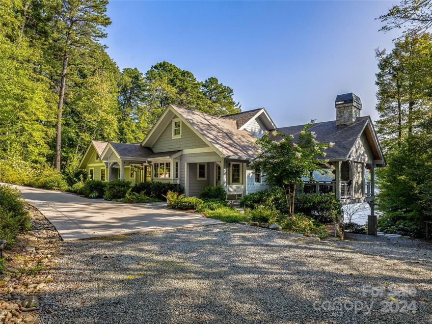 This exquisitely remodeled home on the shores of Lake Toxaway was updated in 2014 with family and friends in mind. 3 bedrooms, 4 1/2 baths and a bonus room. Extensive landscaping surrounds the rear lawn overlooking the private dock. The foyer opens into the living area with a wood burning fireplace and a triple bay window box. The kitchen area overlooks the private entrance and opens onto a porch designed for entertaining. Inside the primary sanctuary is a sitting room with a wood burning fireplace and en-suite bath with double sinks and access to the sun deck. Upstairs, find an additional bedroom with en-suite bath, bonus room, office and ample storage. Downstairs, find a living space with a fireplace and a bunk room. This guest’s paradise includes an outdoor shower off the lower bathroom, a wine room, workshop, ping-pong room and storage for all the water sport toys. This home is the ideal blend of comfort, privacy, function and style for lakefront living at its finest.