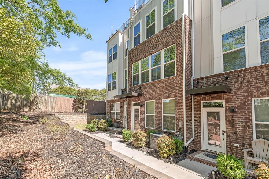 Bright and spacious 4-story townhome conveniently located near Optimist Hall, Uptown, and NoDa. Built in 2020! Home features roof top terrace + open floor plan perfect for entertaining. Modern kitchen has timeless touches, classic shaker cabinets + quartz countertops.

Primary suite features double vanity and custom closet! All three bedrooms feature full ensuite baths. The 4th floor guest suite can accommodate a king, and the loft space is a great separate living area - providing privacy for overnight guests. Loft/flex space leads to a private terrace with a seasonal view of the Charlotte skyline!

Attached 2-car garage + Nest thermostats. Grab lunch or dinner from Optimist Hall, or enjoy the greenway after work (entrance at 16th & Davidson). The Parkwood light rail station is 2 blocks away and provides quick access to uptown, NoDa, and SouthEnd. HOA includes water and maintains all landscaping. All appliances stay! Home is nestled against mature trees - provides lots of privacy!
