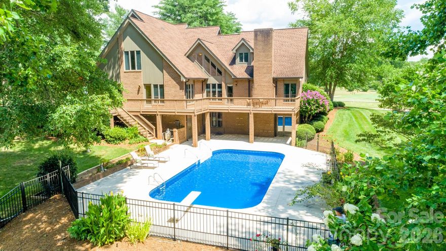 Experience the perfect blend of tranquility and lifestyle in this beautifully updated country club home, ideally positioned to capture breathtaking golf course views in the front and peaceful pond vistas in the rear. Enjoy stunning sunrises over the fairway and unwind with the natural sights and sounds of water and wildlife from your own backyard.

Situated on a picturesque, nearly one-acre lot, this 4-bedroom, 3-bath home offers both space and character, enhanced by thoughtful updates throughout. The inviting interior features a well-designed layout with generous living areas, abundant natural light, and a seamless connection to the outdoors.

Upon entry, you are greeted by a versatile den or study to your left and an elegant formal dining room to your right. The formal dining room connects seamlessly to the kitchen via a classic butler’s door, perfect for effortless entertaining. The tastefully updated kitchen features premium KitchenAid appliances and a Bosch double wall oven. A central island serves as both a prep station and a social bar, making entertaining a breeze. Nearby, the vaulted breakfast nook—framed by a stunning wall of windows—offers panoramic views of the golf course.  

 The living area is highlighted by a dramatic open staircase and a cozy fireplace, creating a warm, sophisticated atmosphere. Walls of windows invite the outdoors in, with direct deck access making it easy to transition to the backyard retreat.

Overlooking the pond and manicured grounds, the main-level primary ensuite is a masterclass in comfort. The spa-inspired bath features a relaxing jetted tub, updated dual vanity, and a separate shower, plus the convenience of a water closet and two spacious closets.

Completing the main level is a versatile second bedroom—perfectly suited for a home office—and a spacious laundry room featuring a deep utility sink, built-in cabinetry, and integrated shelving.

The upper level offers two additional oversized bedrooms joined by a convenient Jack-and-Jill bathroom, along with a beautifully renovated bonus room that can easily serve as a fifth bedroom or media retreat.

Updated flooring, neutral paint, modern lighting, and refined finishes create a warm yet sophisticated atmosphere throughout the home.

The finished basement provides a versatile recreation space, complete with a gas log fireplace, while additional storage and flexible areas offer room to grow. Outdoors, your private retreat awaits with a fenced yard, in-ground pool, and beautifully maintained landscaping—perfect for relaxing or hosting gatherings.

Perfect for the active lifestyle, the oversized garage accommodates two vehicles and includes a separate golf cart door for easy access to the fairways.

Recent improvements include a new heatpump (2026), updated electrical features, refreshed bathrooms, new pool pump, and numerous enhancements to both function and aesthetic. Practical upgrades such as gutter guards, French drains, and septic system improvements enhance the home’s long-term value and ease of maintenance.

Located in the desirable Shannon Acres community with access to golf, tennis, and clubhouse amenities, this home offers a rare opportunity to enjoy scenic beauty, privacy, and an active lifestyle—all in one exceptional property. Statesville Country Club membership is optional. See www.statesvillecc.com.