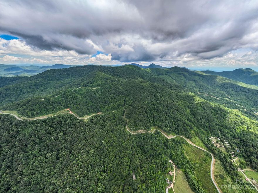 Beautiful lot in desirable Western North Carolina - build your dream mountain home among the rhododendron and mountain laurel and look forward to enjoying an amazing view each day from your property. Paved roads lead directly to the lot granting easy access. The slope of the lot allows for magnificent long-range views. This lot features hiking trails and a waterfall as well! The Summit of Asheville offers a gated entrance, community garden and hiking trails and is located minutes from I-40 access, allowing for a quick drive to Asheville or Waynesville!