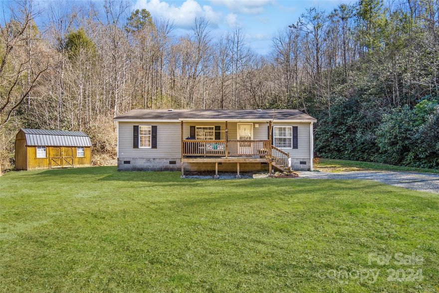 Well-maintained home in a desirable location! Homes in this location don't become available very often. Very nice MFG double wide w/3 beds 2/bath & 2ac of land borders Pisgah National Forest. Features open floor plan from the living room to kitchen. Many updates throughout house w/kitchen cabinets, island, laminate flooring, paint, newer appliances & wall oven. Floor plan has no wasted space; seems larger than the sqft. No restrictions or HOA bringing giving more freedom to do as you wish on your property! The Land has a large yard w/area for a garden & a nice creek running through it! Small spring borders the woods. HVAC for heating & cooling. Well & septic system. Charter internet/cable is available. Enjoy sitting on the nice covered porch enjoying the Blue Ridge Mtns! Very convenient for shopping only 6.5m Main Street Marion/11mi Spruce Pine & Parkway/1.5m Lake Tahoma/8m Lake James, 40 min Asheville/30 min. Morganton Short-term rentals allow 
Back on Market-No fault to the seller.