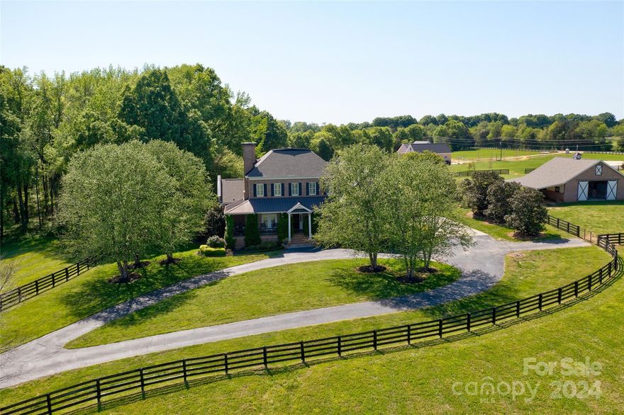 Tirzah Rd is lined w/black board fenced pastures & horse farms making this one of the most scenic roads in York County.  A stacked stone gated entrance, tree lined paved drive between 2 large lush pastures is a pleasure to come home to everyday. The jasmine climbing the brick columns & over the garage is reminiscent of an English countryside estate. A brick 4 stall barn w/concrete center aisle, large sliding end doors & hay loft complement the home. Enjoying coffee & views from the wraparound front porch is the ideal way to start your day. Gourmet meals created in your kitchen w/GE Profile appliances & custom cabinets can be enjoyed while overlooking the pristine pool in your backyard. A main floor primary & a guest rm w/full bath accommodate older guests. Extensive trim work, Brazilian HW floors, Plantation shutters are just a few of the quality features the home offers. A large bonus w/wet bar & adjoining full bath & flex rm are ideal for long term guests. Detailed brochure available