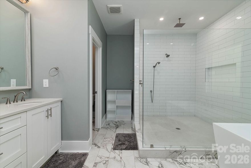 This stunning farmhouse retreat situated on a 1.71-acre private estate (including a 0.134-acre right-of-way) IS MOVE IN READY!! Backed by lush, wooded grounds is designed for both elegance and comfort, offering a gracious southern-style front porch which welcomes you into the heart of the home. A seamless layout and chef’s kitchen showcases a striking quartz island, custom shaker cabinetry, stainless steel appliances, farmhouse sink, and plenty of prep and storage space. This 1 story F.R.O.G. split bedroom plan offers a private sanctuary owner’s suite with his/her custom closets, complemented by a spa-inspired bath featuring heated tile flooring, a luxurious soaking tub, an expansive walk-in shower, and dual vanity. With direct access to the deck, wake up to serene backyard views. Generously sized secondary bedrooms provide comfort and flexibility. Additional highlights include a versatile spacious bonus room over the garage, ideal for a home office, gym, or guest suite, as well as a walk-in attic. A spacious laundry room with storage, a large mud room, and an oversized garage with storage options plus extra parking space for guests, or recreational vehicles. This home offers energy efficiency, with the temperature-controlled crawl space, large enough for additional storage. A newly added eco-friendly 3-stage water filtration system, providing pure, clean water for a healthier lifestyle. Outdoors, enjoy a landscaped oasis with fruit trees, blueberry bushes, and thoughtfully designed privacy plantings. Evenings on your large deck for casual entertaining under the stars. The Low-Maintenance Exterior features James Hardie® Fiber Cement siding that ensures timeless curb appeal with minimal upkeep. This home offers the best of both worlds: the serenity of a private wooded lot with the convenience of being close to shopping, dining, and Lake Norman amenities. Whether entertaining friends, raising a family, or simply savoring quiet evenings, this home is designed to fit your lifestyle.