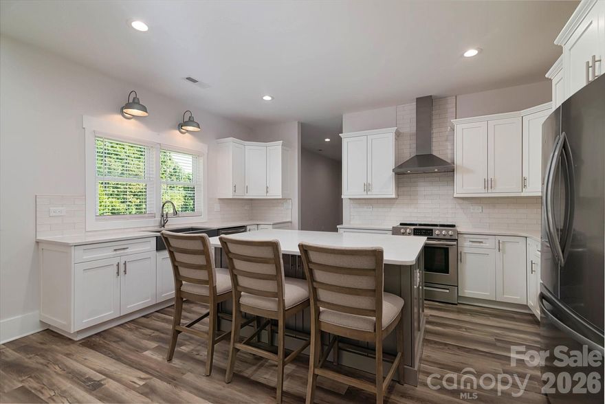 This stunning farmhouse retreat situated on a 1.71-acre private estate (including a 0.134-acre right-of-way) backed by lush, wooded grounds is designed for both elegance and comfort, offering a gracious southern-style front porch which welcomes you into the heart of the home. A seamless layout and chef’s kitchen showcases a striking quartz island, custom shaker cabinetry, stainless steel appliances, farmhouse sink, and plenty of prep and storage space. This one-story split bedroom plan offers a private sanctuary owner’s suite with his/her custom closets, complemented by a spa-inspired bath featuring heated tile flooring, a luxurious soaking tub, an expansive walk-in shower, and dual vanity. With direct access to the deck, wake up to serene backyard views. Generously sized secondary bedrooms provide comfort and flexibility. Additional highlights include a versatile spacious bonus room over the garage, ideal for a home office, gym, or guest suite, as well as a walk-in attic. A spacious laundry room with storage, a large mud room, and an oversized garage with storage options plus extra parking space for guests, or recreational vehicles. This home offers energy efficiency, with the temperature-controlled crawl space, large enough for additional storage. A newly added eco-friendly 3-stage water filtration system, providing pure, clean water for a healthier lifestyle. Outdoors, enjoy a landscaped oasis with fruit trees, blueberry bushes, and thoughtfully designed privacy plantings. Evenings on your large deck for casual entertaining under the stars. The Low-Maintenance Exterior features James Hardie® Fiber Cement siding that ensures timeless curb appeal with minimal upkeep. This home offers the best of both worlds: the serenity of a private wooded lot with the convenience of being close to shopping, dining, and Lake Norman amenities. Whether entertaining friends, raising a family, or simply savoring quiet evenings, this home is designed to fit your lifestyle.