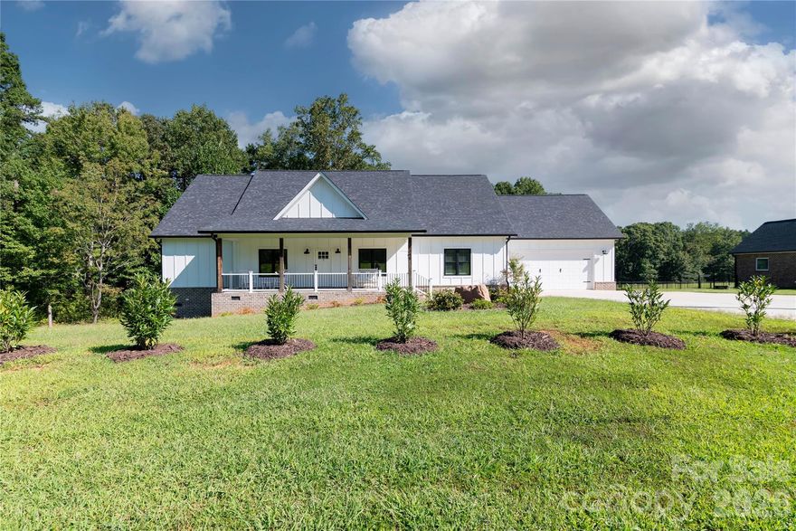This stunning farmhouse retreat situated on a 1.71-acre private estate (including a 0.134-acre right-of-way) IS MOVE IN READY!! Backed by lush, wooded grounds is designed for both elegance and comfort, offering a gracious southern-style front porch which welcomes you into the heart of the home. A seamless layout and chef’s kitchen showcases a striking quartz island, custom shaker cabinetry, stainless steel appliances, farmhouse sink, and plenty of prep and storage space. This 1 story F.R.O.G. split bedroom plan offers a private sanctuary owner’s suite with his/her custom closets, complemented by a spa-inspired bath featuring heated tile flooring, a luxurious soaking tub, an expansive walk-in shower, and dual vanity. With direct access to the deck, wake up to serene backyard views. Generously sized secondary bedrooms provide comfort and flexibility. Additional highlights include a versatile spacious bonus room over the garage, ideal for a home office, gym, or guest suite, as well as a walk-in attic. A spacious laundry room with storage, a large mud room, and an oversized garage with storage options plus extra parking space for guests, or recreational vehicles. This home offers energy efficiency, with the temperature-controlled crawl space, large enough for additional storage. A newly added eco-friendly 3-stage water filtration system, providing pure, clean water for a healthier lifestyle. Outdoors, enjoy a landscaped oasis with fruit trees, blueberry bushes, and thoughtfully designed privacy plantings. Evenings on your large deck for casual entertaining under the stars. The Low-Maintenance Exterior features James Hardie® Fiber Cement siding that ensures timeless curb appeal with minimal upkeep. This home offers the best of both worlds: the serenity of a private wooded lot with the convenience of being close to shopping, dining, and Lake Norman amenities. Whether entertaining friends, raising a family, or simply savoring quiet evenings, this home is designed to fit your lifestyle.