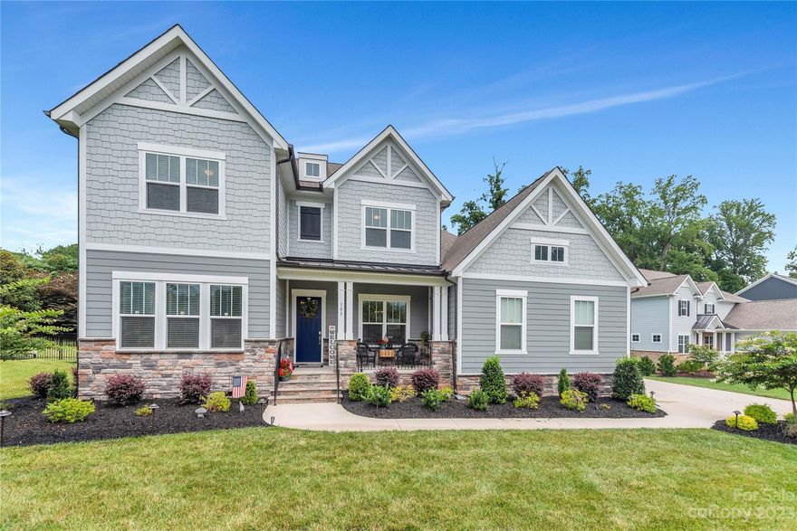 Welcome to Belmont's McLean - South Shore, a picturesque waterfront community only 20 minutes from the Charlotte Airport....  offering residents exclusive access to a clubhouse, pool, playground, and trails. 105 Shimmer Lake Lane, built by John Wieland Homes, is a stunning 2.5-story retreat that offers the perfect balance of comfort and style.  As you explore the property, you'll appreciate the thoughtful upgrades and meticulous attention to detail. The 3-car garage provides ample space for vehicles and storage. Enjoy the fenced backyard with oversized screened in porch and composite deck featuring aluminum and cable railing. Inside, the home exudes elegance with custom paint throughout, creating a unique and personalized atmosphere. Upgraded lighting fixtures grace the master bedroom, dining room, cafe, kitchen, and living room. The owner’s suite on the main level has a spa-like atmosphere... including step in shower and a designer closet complete with built-in organizers.