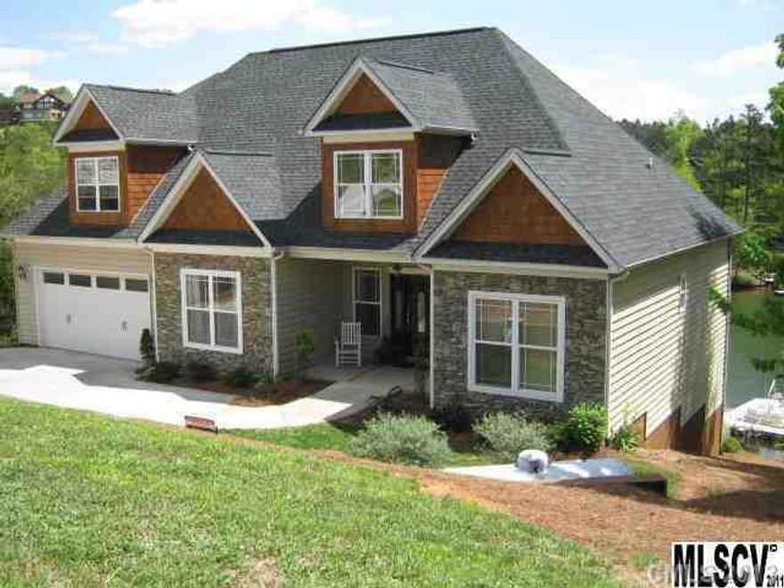 Beautiful setting from this stunning lakefront home with 145' of waterfront and views of the lake from most rooms. Nice large decks for entertaining. There is a large boat dock with a fire pit nearby. The home is very spacious with glistening hardwood floors. The gourmet kitchen includes granite countertops, cherry cabinets, stainless steel appliances and a breakfast bar. Beautiful moldings.