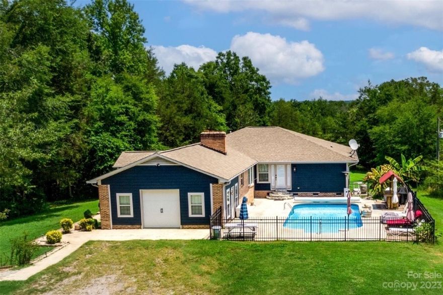 Private 13.65 acres with gated drive, pond stocked with bass brim, bluegill and shell cracker.  The beautiful saltwater pool comes with a water feature and tiki bar.  
Spacious kitchen equipped with double convection oven, indoor grill, German hand hammered copper sink, custom cabinets, and granite countertops.
Australian cypress flooring throughout common space that includes the garage that has been finished and used as a family/rec room.

Extra-large custom owner's suite features his and hers full baths connected by a large walk-through closet.

Property has Generak generator with propane tank that will run the entire home, along with a two stall shed and storage building.

Garage is finished and includes its own PTAC (Package terminal air conditioner) and is currently counted as additional sq/ft.