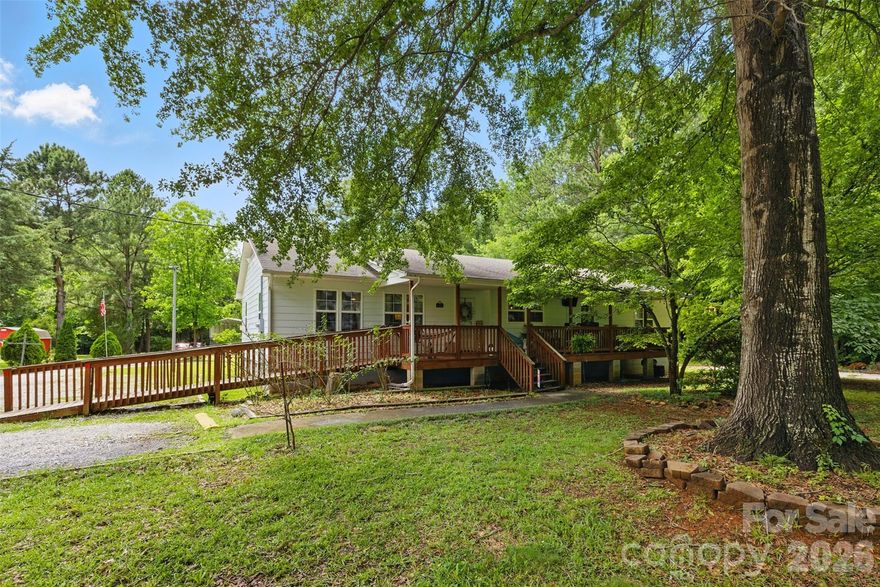 NO HOA! ***Assumable 3.99% ANNUAL PERCENTAGE RATE!** One of the lowest priced 4 bedroom, 3 FULL bathroom homes on .67 acre in the heart of Indian Land. The moment you step onto the sprawling covered front porch via accessible ramp, you will feel the warmth of country living with all the modern-day conveniences just minutes away. The porch spans the full length of this nearly 2000 sq ft home, offering a spot for morning coffee or evening relaxation. Inside, the bright, open layout creates an inviting space for everyday living and entertaining. The kitchen features a gas range, perfect for home chefs who love to cook, oak cabinets and all appliances stay — including the refrigerator, washer, and dryer! With three full bathrooms, everyone has their own space — no waiting required! The expansive lot provides plenty of space to garden, play, park your RV on concrete pad, or simply enjoy your own piece of Indian Land. HVAC replaced in 2019. Tucked away, yet convenient to award winning schools, the new Target and Costco shopping centers, and popular restaurants. Done miss this rare opportunity to own a spacious, well-appointed home with NO HOA in one of the most desirable areas around!