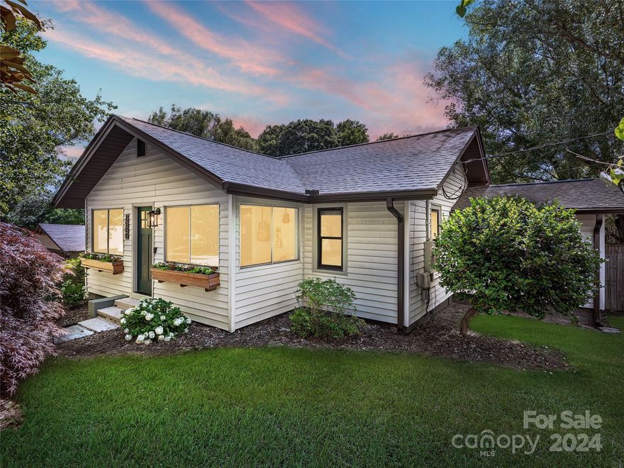 Welcome to this charming 3BR/ 2BA bungalow home nestled on a generous half-acre lot in the heart of Hendersonville. The property boasts a spacious, beautifully landscaped yard, perfect for outdoor activities, gardening, or simply enjoying the private oasis. The home has been thoughtfully & creatively updated & remodeled, with attention to the details & finishes.  Step inside the light-filled sunroom & continue into the open living room.  The kitchen boasts a spacious dining area as well as access to the covered back deck.  The primary bedroom is filled with light & offers access to the back deck & yard. The two additional BRs feature wood floors, updated finishes, ceiling fans, with one offering a sitting area & Murphy bed. Outdoor living is a highlight of this property, with featuring mature shade trees, custom firepit area, custom playground area & large decks. Multiple outbuildings provide unlimited possibilities, with one being used as a bar & entertainment area.