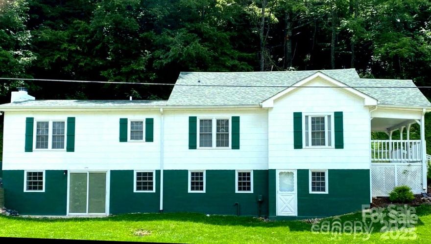 Beautiful setting just minutes from downtown Bakersville. 

Farmhouse style home built in 1950 features living room walls with stunning wood from 1942. Spacious kitchen has custom built wood cabinets. Enjoy your lovely view from the kitchen window. Renovated attic is great office space (not included in square footage).

Renovated large laundry room, kitchen, bathrooms, all with ceramic tile, lots of cabinets. New covered front porch, shutters, tilted windows and landscaping. New sheetrock, insulation, beadboard and paint throughout. New doorknobs, new laminate flooring. Oil furnace heats main floor, new electric wall heat as shown. Ceiling fans in most rooms, three window air conditioners. Large patio.

New electric wiring, roof, septic & septic pump, drain system, hot water heater, and double doors in back. Exterior was sealed with 100% asbestos sealer & painted.

This mostly renovated home gives you time to relax on the front porch and listen to the nearby babbling creek.