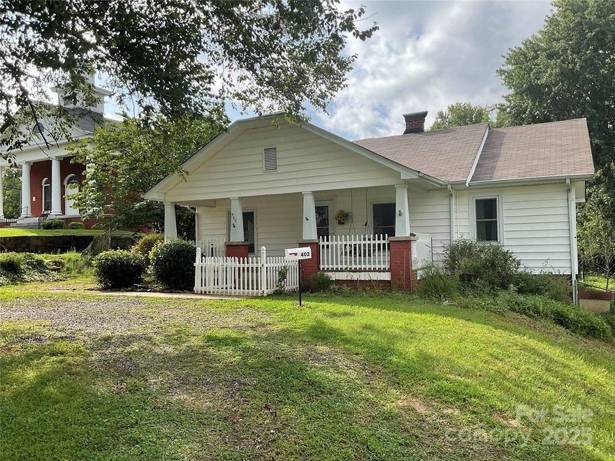 An oldie but a goodie! Relax on the front porch swing with your morning coffee or enjoy an evening chat with a neighbor. The roof was replaced in 2021, and all double-pane windows have been added over the past few years. The fireplace and chimney were cleaned in 2021. Originally listed as a 3-bedroom, 1-bath home in tax records, but one bedroom has been converted into a full bathroom. French drains have been installed on the left side of the house and near the back porch. The fully fenced backyard is filled with various trees, including apple and peach trees, perfect for enjoying the outdoors. Choose your favorite paint color and flooring style to turn this house into the home of your dreams.
