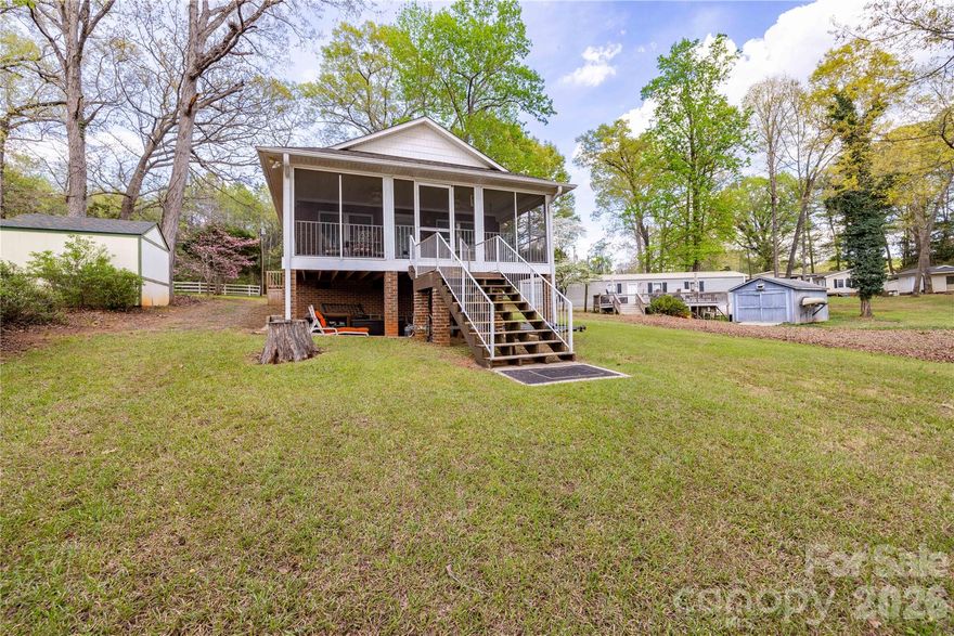 Lake Tillery Waterfront Home with 2 bedroom and 2 full baths. Positioned in a quiet cove just off the main channel. This property will convey fully furnished and everything that is currently in the home will come as well.....tv's, linens, towels, plates, pots, flatware.......EVERYTHING !! Brick construction built in 2002 with a flat roof boathouse and two slips with lifts. Very gentle slope to the dock and a large screened porch for relaxing. Just bring your bathing suit / toothbrush and you are ready for Summertime Living on Lake Tillery !!!