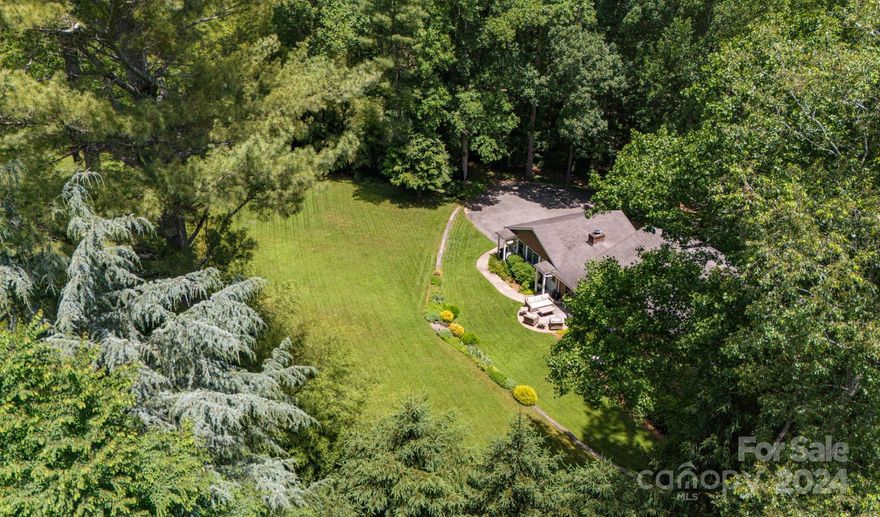 Back on the market through no fault of home, no damage from Helene! Mid Century Biltmore Forest Home on 2.71 Acres Picture perfect classic 1956 two-story ranch style, situated on a pristine, quiet and large private lot!! |  Great,  value priced home in Asheville’s premier neighborhood! This solidly built home is ready for modern updates.  Very spacious outdoor living options; ideal for entertaining.   Five bedrooms and three full bathrooms. All oak hardwood floors.  Enjoy the ambiance & solitude of this property’s location. Nestled within the town of Biltmore Forest; a highly sought-after community!  Biltmore Forest amenities include: tree lined streets, Rosebank and Greenwood parks, Carolina Day School (K-12), as well as the security of its own robust police force. Direct access to Blue Ridge Parkway. Asheville's best kept secret could be yours!  Large clean basement storage with built in shelves,has great potential. A great value!! Surrounded by multi-million dollar homes.