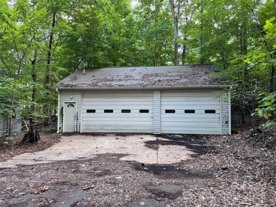 Discover the potential of this 2.82-acre wooded lot, complete with a 36x32 wired garage/workshop featuring a half bath—perfect for hobbies, storage, or future projects. The property also includes two additional storage buildings and a 2-car metal carport. A mobile home currently sits on the property but holds no value and will need to be removed, leaving a great opportunity to build your dream home or place a new dwelling. Don't miss this versatile piece of land with valuable infrastructure already on site.