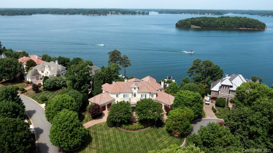 Savor unrivaled panoramic sunsets from this stylish Mediterranean villa perched spectacularly above Lake Norman in The Peninsula. Sumptuously appointed with hand painted ceilings and polished marble floors, this flagship estate features a signature two-story foyer & great room w/palladium windows and expansive lake views. Dual island gourmet kitchen adjourns perfectly to an intimate covered veranda. Lake level entertaining features bar, billiards, resort pool/spa, and private putting green.