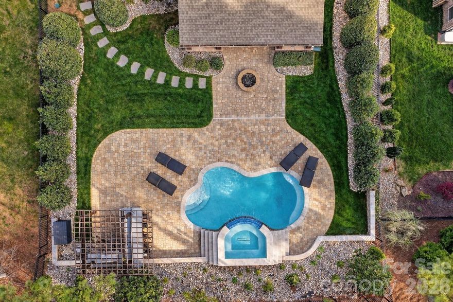 Welcome to 1011 Rock Forest Way, where refined living meets resort-style outdoor elegance in the highly sought-after Barber Rock community of Indian Land . Featuring 5 bedrooms and 3 full bathrooms and a flex room.

From the moment you enter, you’re greeted by an open-concept floor plan enhanced by rich hardwood flooring, tray ceilings, and a warm, inviting fireplace. The heart of the home is a beautifully appointed  kitchen, complete with a spacious island, ample cabinetry, and seamless flow into the living and dining areas.

A private backyard retreat. Designed for elevated outdoor living, this space features a sparkling salt water pool and a fully equipped outdoor kitchen, creating the ultimate setting for entertaining, relaxing, and enjoying Carolina evenings. Whether hosting summer gatherings or unwinding in your own oasis, this backyard delivers a luxury experience rarely found in the area.

Inside, generously sized bedrooms and flexible living spaces provide endless possibilities for guest suites, home offices, or media rooms. 

Situated on a level, fenced lot with a two-car garage, this home is part of a vibrant community offering amenities such as a pool, playground, and scenic walking trails.

Located just minutes from Ballantyne, Fort Mill, and premier shopping and dining, 1011 Rock Forest Way offers the perfect blend of luxury, location, and lifestyle.