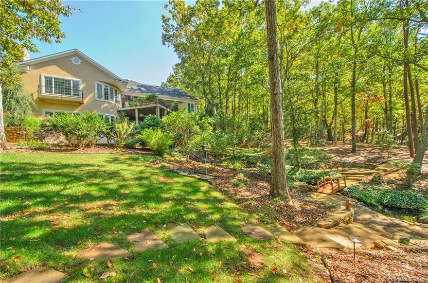 Capture nature and lake living in harmony. The winding entrance welcomes you home to a natural paradise with spectacular sunsets and breathtaking lake views. Wake up everyday feeling like you are on vacation just steps to your private dock for all your fishing and boating adventures. Almost 3 acres of beautiful landscaping featuring a cascading waterfall, pond, and extensive stonework  Incredible commanding lake views from almost every room. Separate workshop, approved for additional guest home.