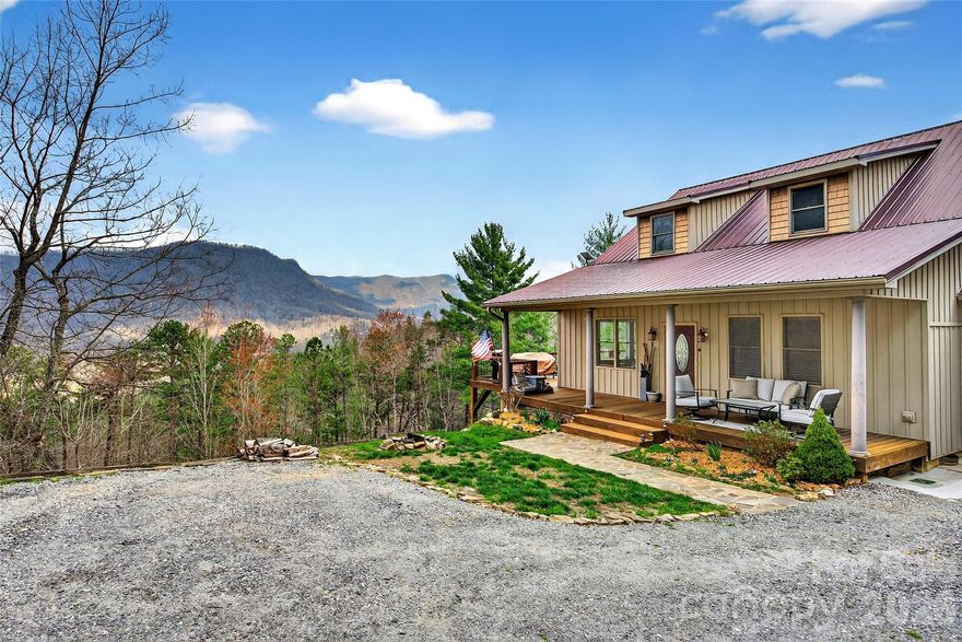Welcome to one of the most special properties you will find in the Western North Carolina mountains. Immaculate and private home on 1.8 acres adjoining the Pisgah National Forest, tucked away in a peaceful gated community offering year round views of Honeycutt and Humpback Mountains. This bright, open floor plan home features 1,771 total square feet of living area with 3 bedrooms, 3 bathrooms, (2-bedroom septic permit) insulated Pella windows throughout the whole house, wood, tile, and carpet flooring, a breakfast bar, wine refrigerator, gas stove, central island and outside a spacious wraparound deck perfect for taking in the surrounding beauty. The basement level provides separate living quarters that the owners successfully rented on Airbnb for years, generating excellent revenue. Additional highlights include a whole house Generac generator, on demand water heater, propane tank and gas logs fireplace. In the oversized primary bedroom suite enjoy soaking in the large jacuzzi bath tub. The attached one car garage benefits from direct kitchen access and an electric vehicle charger. Rare combination of end of the road privacy and true mountain tranquility. Centrally located between Boone (40 minutes) and Asheville (50 minutes), and only 30 minutes to ski resorts, 25 minutes to Lake James, 15 minutes to Linville Gorge Wilderness, and 10 minutes to the Blue Ridge Parkway, Linville Falls, and Linville Falls Winery. Call today to schedule your showing of this one of a kind property.
