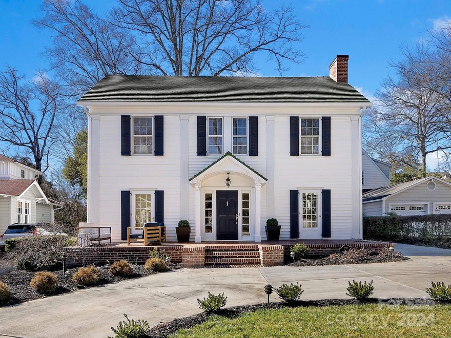 This 1920s Myers Park gem masterfully merges classic charm with modern updates. The renovation preserves the home's original allure, enhanced with contemporary finishes. Features include high ceilings, detailed moldings, and gleaming hardwoods. The welcoming great room with its original fireplace leads to a formal dining room and a study with classic built-ins. The stunning kitchen boasts custom cabinets, Calcutta marble countertops, and high-end appliances, complemented by a large island, cozy keeping room feel with a fireplace next to the eat in breakfast area, and a walk-in pantry. The main level includes a tastefully updated bedroom and full bath, while upstairs hosts five more bedrooms and two modern baths. The property offers a spacious lot, new driveway, and a two-car detached original garage with potential for a bedroom and full bath above, adding to its charm and value.