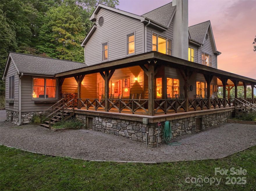 Extraordinary Farmhouse Retreat at Laurel Ridge Country Club
Experience refined mountain living in this stunning 4-bedroom, 5.5-bath farmhouse that perfectly blends rustic charm with modern luxury. Set on over 5 private acres across two lots, this property offers both serenity and sweeping, long-range mountain views from nearly every room.

With 4,745 square feet of heated living area—including more than 700 square feet above the garage—this home was designed with space, comfort, and versatility in mind. The open main level welcomes you with soaring ceilings, exposed beams, and walls of windows that bring the mountains right inside. The kitchen opens into a warm and inviting great room anchored by a stone fireplace.

Step onto the expansive wrap-around deck and take in panoramic vistas of the mountains and valley below—perfect for entertaining, relaxing, or simply soaking in the beauty of Laurel Ridge. Each bedroom offers its own privacy and luxury for family or guests. The home also features a gracious primary suite, elegant dining area, and multiple living spaces ideal for gatherings or quiet reflection.

Located in the sought-after Laurel Ridge Country Club community, this property combines privacy with convenience—just minutes from downtown Waynesville’s dining, shopping, and golf. With its craftsmanship, acreage, and breathtaking views, this mountain retreat is truly one of a kind.