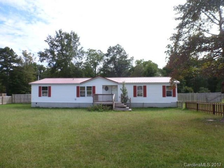 Three bedroom, 2 bath dblwide mobile home, built 1999, has new metal roof on .69 acre lot, fenced front and back. Living room with fireplace, lots of counter space in kitchen, stove and microwave remain, master bath has garden tub, dbl vanities and separate shower.