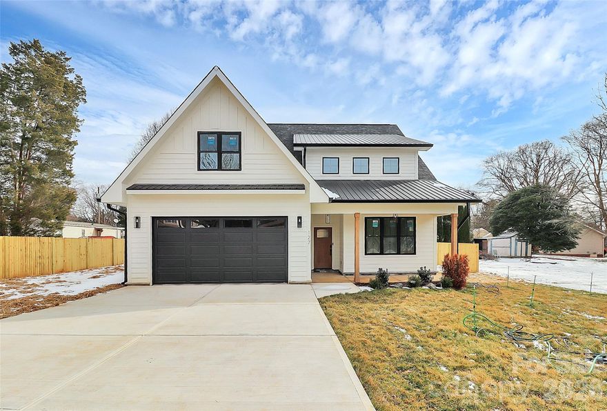 Discover 127 Hazelton Loop, a beautifully crafted new home in Mooresville, ideally located across from Lake Norman. This 4-bedroom, 3.5-bath residence offers approximately 2,815 sq. ft. of modern living space designed for comfort and style. The open-concept layout showcases a gourmet kitchen with quartz waterfall counters, stainless steel appliances, and custom cabinetry. The main-level primary suite features a soaking tub, walk-in shower, and dual vanities. Upstairs, enjoy a dedicated media room with built-in ceiling speakers and subwoofer perfect for movie nights or entertaining. With spacious secondary bedrooms, a 2-car garage, large driveway, and no HOA, this home combines function and flexibility. Conveniently situated near Mooresville’s shopping, dining, and Lake Norman recreation. Includes participation in a 2-10 Home Buyers Warranty program, providing coverage comparable to that offered by many national builders.