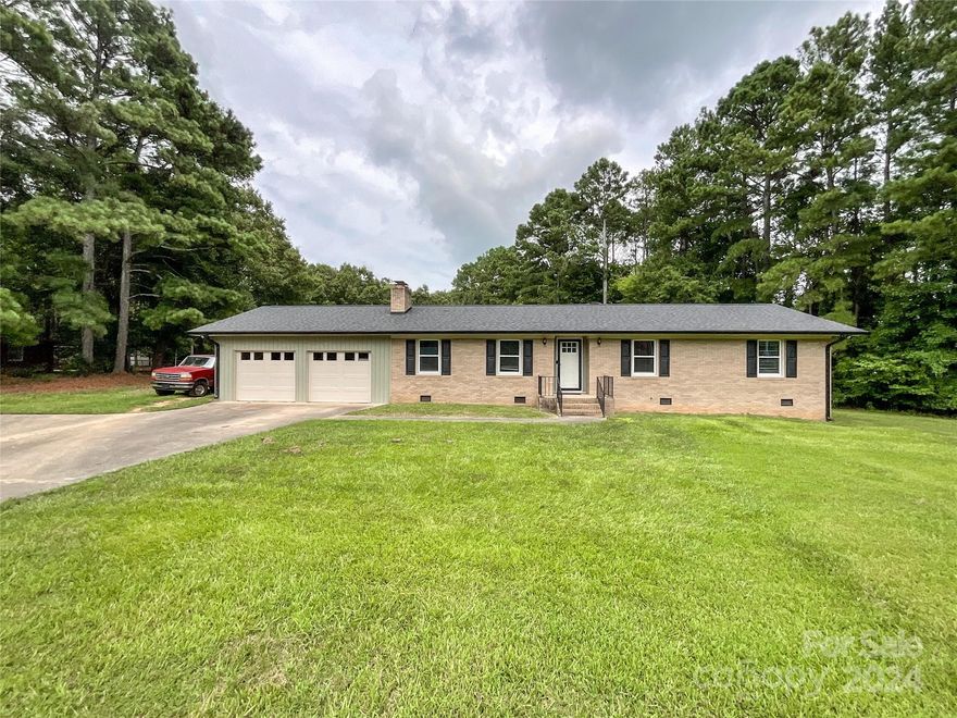 No HOA!  Established neighborhood.  Full brick beautiful ranch home with wood flooring throughout, tile in bathrooms, attached oversized two car garage with storage area.  Large living room with coffered ceilings and chair railings, brick wood burning fireplace with rustic mantel.  Large eat in kitchen.  Sun room with French doors.  Oversized laundry room off kitchen, and second, detached garage (882 sq ft) in huge back yard.  Oh...did I say 1.89 acres?  Newly painted interior with some new doors.  Roof 2020. Appliances 2021. Wood floors 2019, Siding on garage 2023, Countertops 2022. HVAC 2012.