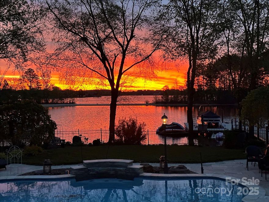 Resort-style living on Lake Norman with this spectacular sunrise waterfront home in The Peninsula under $3M!!!  Main level features radiant heated wide-plank tile floors, soaring ceilings, extensive millwork, formal dining, office with barn doors, and a spectacular chef’s kitchen with Sub-Zero, Wolf range, wine fridge, beverage drawers, and custom coffee center. Great room with fireplace opens to screened porch with fireplace and grilling deck, all overlooking heated saltwater pool, spa, and shared (deep water) dock with boat lift, jet ski ports, and kayak rack. Upstairs, the owner’s retreat boasts a sitting area with fireplace, spa bath, dual closets, and terrace with lake views. Secondary bedrooms include an ensuite with window seat, another with shared full bath and loft with custom built-in office/reading nook, plus a versatile bonus/4th bedroom with wet bar, walk-in closet, and window seat. 3-car garage, walk-up attic, and tremendous storage complete this exceptional home. Updated and Many Upgrades!