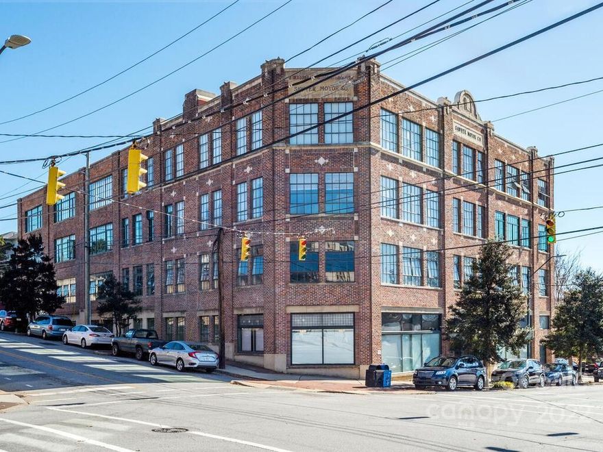 Remarkable mid-rise condo with spectacular views in downtown Asheville's historic Sawyer Motor Building! Enjoy a rewarding urban lifestyle in this 2-br/2-bath corner unit with large windows that showcase the breathtaking western views overlooking the city against a backdrop of long range layered mountains. Special features include the spacious open floor plan, heart pine flooring, high ceilings, and overall unique character. The kitchen touts stainless steel appliances, breakfast bar, granite counters, tile backsplash, and fantastic style! Each bedroom boasts enormous closet space. 2nd primary bedroom includes a Murphy bed. Additional highlights include access to the amazing rooftop terrace, 2 secure parking spaces on the 2nd level garage, and an unbeatable location in the cherished core of Asheville!