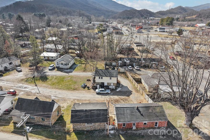 Rare redevelopment assemblage in the heart of Waynesville’s South Main corridor: this combined offering includes 1.53 acres with 15 existing rental units across two contiguous parcels, zoned South Main Business District (SM-BD) with flexible commercial and multifamily use potential. Parcel 1 (0.709 acres) includes a freestanding 1,746 sq ft commercial building, a triplex-style stone structure, one duplex, and two freestanding apartments—7 units total. Parcel 2 (0.82 acres) features 8 residential units across multiple cottages and duplexes, with 7 of 8 currently occupied. One unit is uninhabitable due to past flood damage. All structures are mid-20th-century and in fair to poor condition, with deferred maintenance, aged roofs, and no central HVAC. This site is priced for land value and upside, not stabilized income. Zoning allows for a wide range of future uses, including multifamily, mixed-use, retail, office, or boutique hospitality. Walkable to Ingles, Walmart, breweries, restaurants, and downtown Waynesville. The parcels back to the newly revitalized Waynesville Inn & Golf Club and sit within the designated South Main Redevelopment District, offering visibility, scale, and access for developers. Combined, the parcels create a rare infill footprint with Main Street frontage, public utilities, and proximity to growing commercial anchors. Buyers may explore adaptive reuse or full redevelopment. Do not disturb tenants. Showings by appointment only.

-