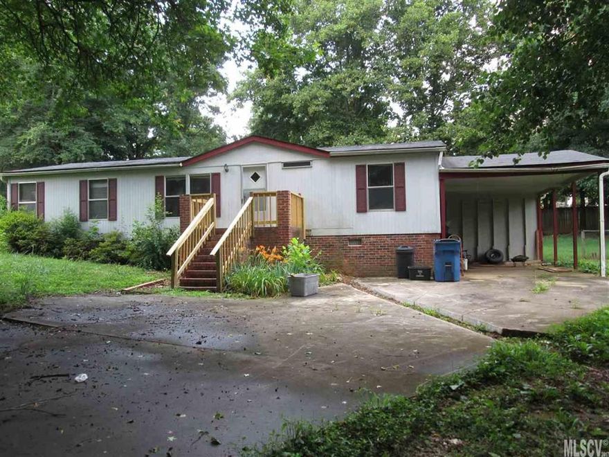 This 3 bedroom 2 bath manufactured home sits on a lot with shade trees in the front and a cleared fenced back yard.   Home is in need of TLC.  Living room has a wood burning fireplace.  Master bedroom with a walk-in-closet and master bath has a separate shower and garden tub.  Galley style kitchen.  Split bedroom floor plan.  Being sold "AS IS WHERE IS"