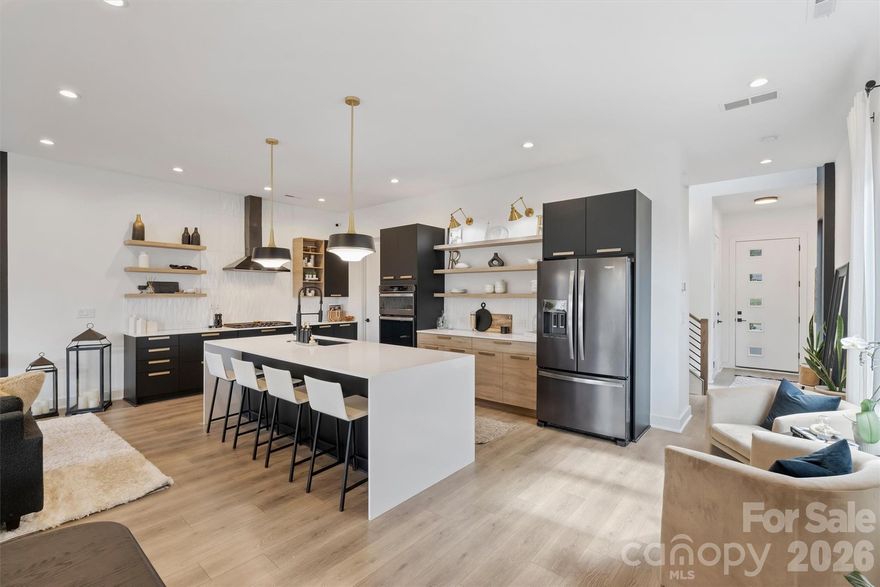 Modern elegance meets effortless city living in this beautifully designed townhome just moments from the energy of the city. Thoughtfully crafted with sophisticated finishes and distinctive architectural details, this residence offers a refined yet comfortable lifestyle. At the heart of the home, the chef-inspired kitchen makes a striking impression with a dramatic waterfall-edge island, an oversized gas cooktop with split cooking, sleek black stainless appliances, and stylish open shelving that blends form and function. The open-concept design creates a seamless flow between the kitchen and living spaces, perfect for entertaining or enjoying everyday moments in style. The primary suite serves as a private retreat, complete with a custom-designed closet and motorized window shades that add both luxury and convenience. Throughout the home, elegant custom drapery enhances the modern aesthetic and will remain with the residence. Thoughtful details set this home apart, including a charming built-in dog room tucked beneath the stairs, creating a cozy space for four-legged family members.
Outdoor living is equally inviting with a covered patio designed for year-round enjoyment, complete with a dedicated gas line for grilling. The private fenced yard offers a rare outdoor sanctuary for a townhome so close to the city. Blending modern design, distinctive features, and an exceptional location, this residence delivers a lifestyle defined by comfort, style, and convenience. Beyond the home itself, the location offers the best of city living with close proximity to restaurants, shopping, entertainment, and daily conveniences. Enjoy the ease of being near everything the city has to offer while still having a comfortable and stylish retreat to call home.