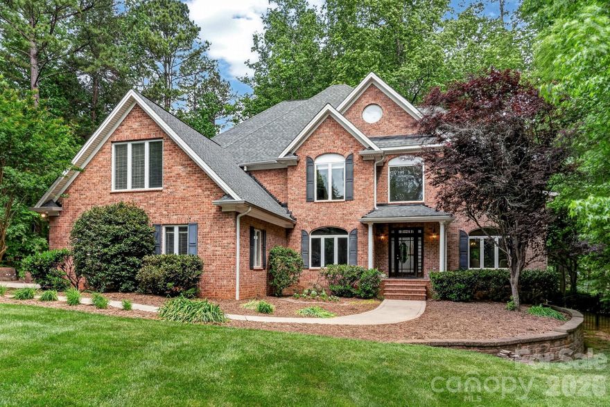Discover this impressive, meticulously maintained brick residence nestled in one of Davidson’s most charming neighborhoods, offering the perfect blend of privacy and accessibility just minutes from downtown shopping, dining, and community events. Set on a large, flat lot, this property is a true, quiet retreat featuring a beautiful stone patio with a tranquil water feature—perfect for relaxing or entertaining in a serene outdoor setting. The grounds are secured by 54” wrought iron fencing with three gates and serviced by a full-yard irrigation system. A driveway chime alerts you to visitors, while the large parking area leads to a 3-car garage, plus a separate workshop/garage with a one-car bay that could easily be converted into further space. Inside, you are welcomed by a spacious and inviting layout characterized by hardwoods throughout the entire home and elegant stained-glass transoms. The warm family room, featuring a wood-burning fireplace, flows seamlessly into a gourmet kitchen outfitted with custom cabinetry, a walk-in pantry, a kitchen island with a prep sink, and premium Thermador appliances including a gas cooktop and electric wall oven. A formal dining room adds elegance for special occasions, while a main-level office provides a convenient work-from-home option. Addit
ional living space offers flexibility as a reading room or music area, and the generously sized laundry room includes room for an extra refrigerator for added convenience, with a wine refrigerator. Upstairs, the expansive primary suite serves as a true retreat, complete with its own gas fireplace, a private sitting area, and a large master bath with a garden tub. Large secondary bedrooms and custom closets with custom shelving provide ample space for family and guests, while a versatile bonus room functions perfectly as a media or game room. This home is built for longevity with significant updates, including a new roof (2026), a Goodman 2nd-floor heat pump (2021), a 1st-floor HVAC (2017), an 80-gallon water heater (2019), and high-efficiency performance toilets. Massive storage options abound, from the shelving-lined walk-in attic to the large walk-in crawl space with a built-in workbench. Beyond the property, enjoy effortless access to neighborhood walking trails, the Greenway, and Fisher Farm Park for ultimate outdoor enjoyment. Plenty of backyard space to put in your dream pool.