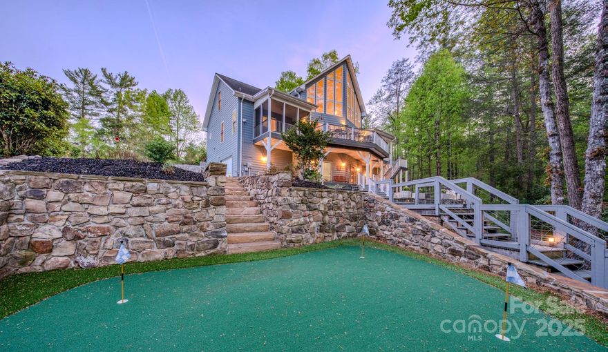 WATERFRONT WITH DOCK & BOAT LIFT!!! Meticulously well kept home with two tiered boat dock on Lake James in a quiet, private cove for all your watersport activities. Just a few steps from the back patio to the boat dock and custom-designed and professionally installed putting green! Charming wood burning stove in this 4 bedroom/4 bath home perfect for entertaining family and guests at Lake James. Additional bonus room in loft currently used as an Office. Primary suite offers a screened deck with Lake View for year round enjoyment. Each level of the home is independently heated and cooled.  Lakeside is wrapped in decks and flagstone patio, circular driveway in front for guests and oversized two car garage currently houses 18 foot Chapparal ski boat and trailer, (also included in sales price), so no storage needed for off season! House being sold fully furnished (inside and out) so just bring your clothes and hit the water! Endless outdoor opportunities with State Park trails near by.